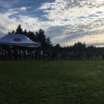 A wide view of the long line of people at the park.