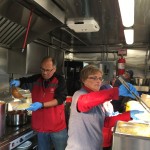 Food service volunteers busy preparing food.