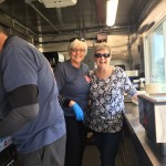 Food service volunteers smile for a photo.