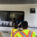 Volunteers receiving refreshments through the canteen truck window.