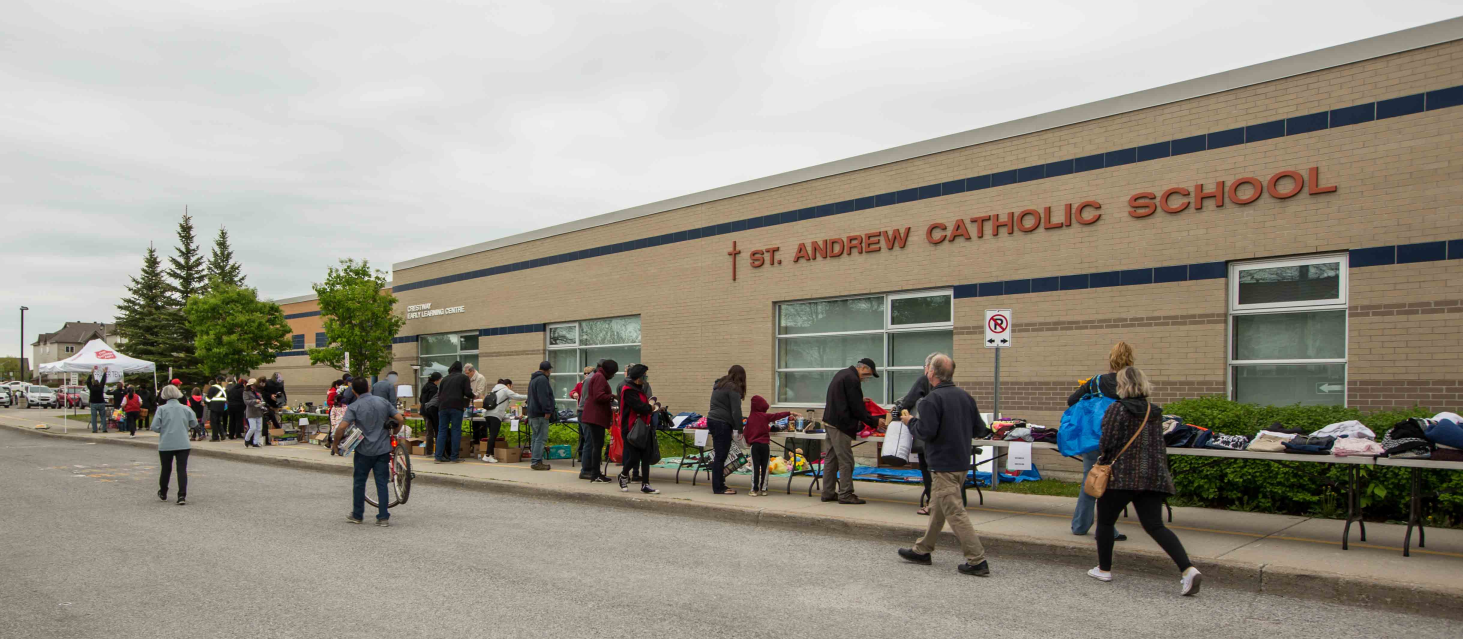 The Big Give Overview2 resized People browse clothing and household items offered for free.